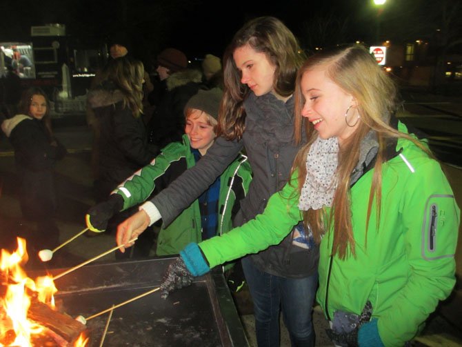 The Newell family of Vienna roasts marshmallows over an open fire during the first annual First Night Vienna celebration, held December 31, 2013, along the Church Street corridor.
