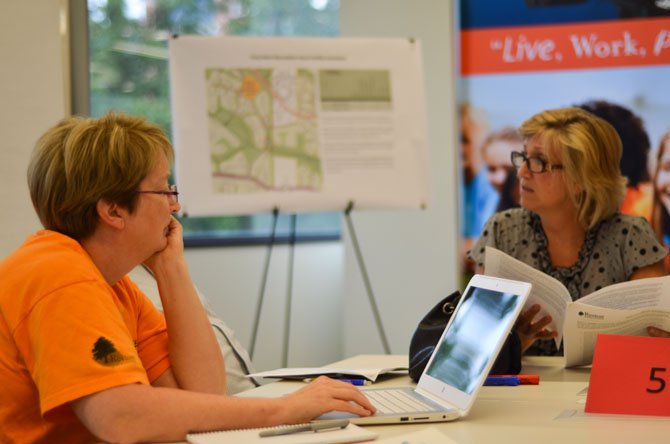 Reston residents, including Mary Ellen Erickson and Kelley Westenhoff, attended a public meeting at the Reston Association building regarding possible development of the Pony Barn Picnic Pavilion.

