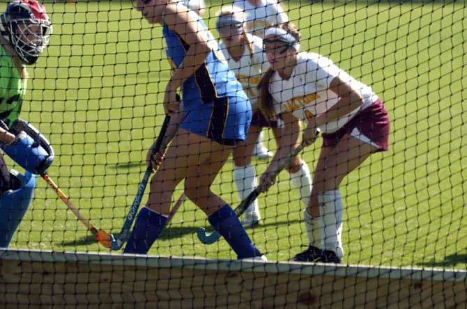 Oakton sophomore Maddie Rouse, right, scored two goals during the Cougars’ 5-1 victory over Osbourn Park on Monday.