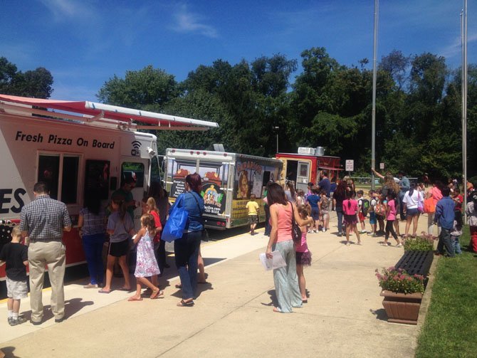 During the August open house at Herndon Elementary, food trucks including Rito Loco, DC Slices and Safari Ice were parked by the curb as families visited the school.
