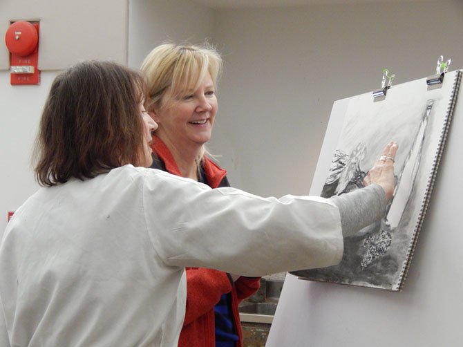 MPA art Instructor Marise Riddell works with student Lee DiCenso on her drawing. 
