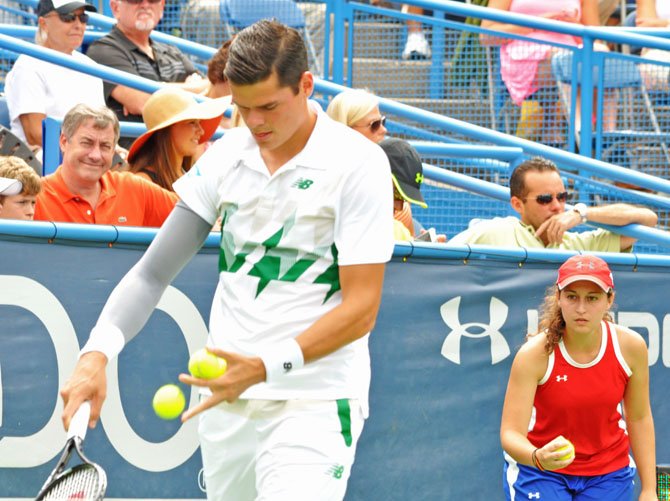 Nikki Furst, of Fairfax, is prepared to collect any balls that fall and has a fresh tennis ball ready during Milos Raonic's serve. Raonic is ranked sixth in the world by the ATP and went on to win the tournament in the first all-Canadian men's final in the Open Era.
