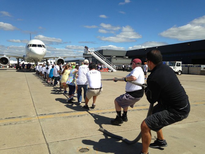 Teams of 25 will compete to see who can pull the airplane 12 feet the fastest.