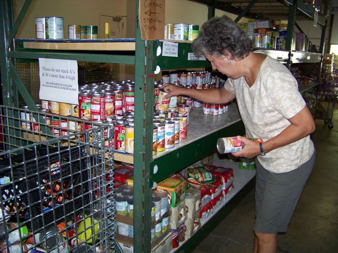 A volunteer working in the Food for Others warehouse.

