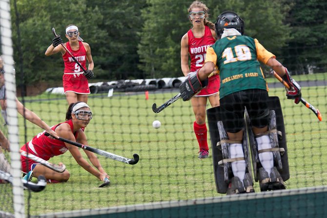 Senior forward Julia Lee (ground), junior center back Rachel Maizel (9) and junior center midfielder Marisa Morakis are three of the Wootton field hockey team’s top players in 2014.