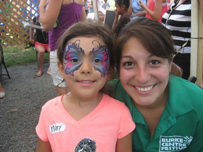 Mary, 5, and Natasha Solano participate in face painting, one of the activities at the Burke Centre Festival on Saturday, Sept. 6.
