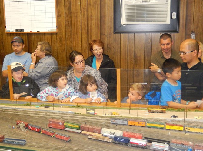 Families having fun at the model-trains display.