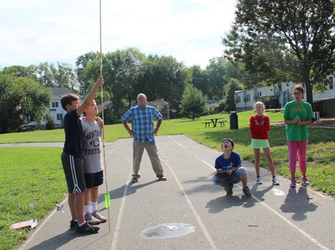 Under the watchful eye of Greg Butler, Churchill Road sixth graders Benjamin Scott, Ben Thrasher, Jimin Byeon, Audrey Leins and Katie Williams wait expectantly to see how high their rocket will go.