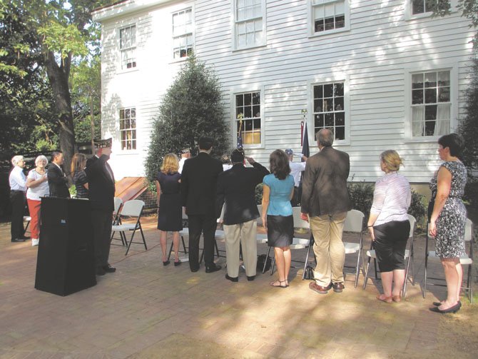 Elected officials honor the American flag as the Vienna Choral Society sang the National Anthem.
