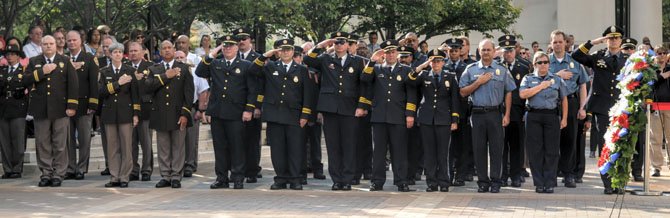Arlington Public Safety officers and staff stand at attention as a moment of silence is called at 9:37 a.m.