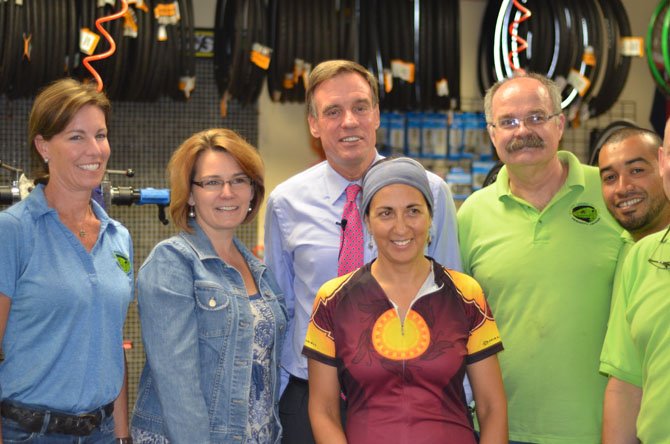 Liz Shipley, Town of Herndon Mayor Lisa Merkel, Senator Mark Warner, Olivia Ruizamora, Les Welch, and Stephen Vides at the Green Lizard bike shop in Herndon.