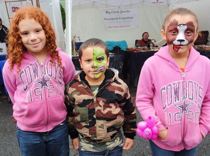 The Thornton siblings (from left) Saniya, 7, Devin, 5 and Savina, 6, visited the face painter at Clifton Day 2013.