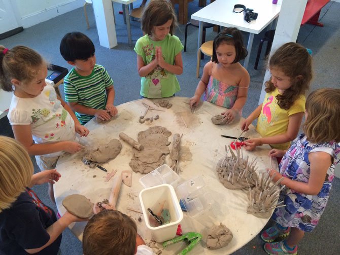 Children at Art at the Center in Mount Vernon prepare to use clay. Art as mindfulness helps children shift from feeling a need to control the process and gives them the freedom to simply create.