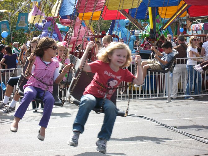 Children enjoying an amusement ride at last year’s event.