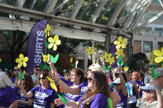 Before the Sept. 28 2014 Walk To End Alzheimer’s at Reston Town Center began, participants were asked to raise their Promise Flowers. Promise Flowers represented the diverse reasons participants gathered for the event.
