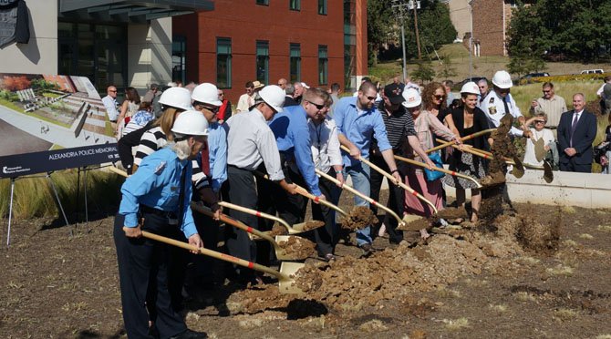 Alexandria Police Chief Earl Cook, far right, is joined by family members of police officers killed in the line of duty in breaking ground on the Fallen Officers Memorial Sept. 27 at police headquarters. 