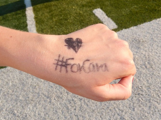 Centreville High cross-country runners Tuesday wrote “#ForCara” on themselves in Cara Golias’s memory. 