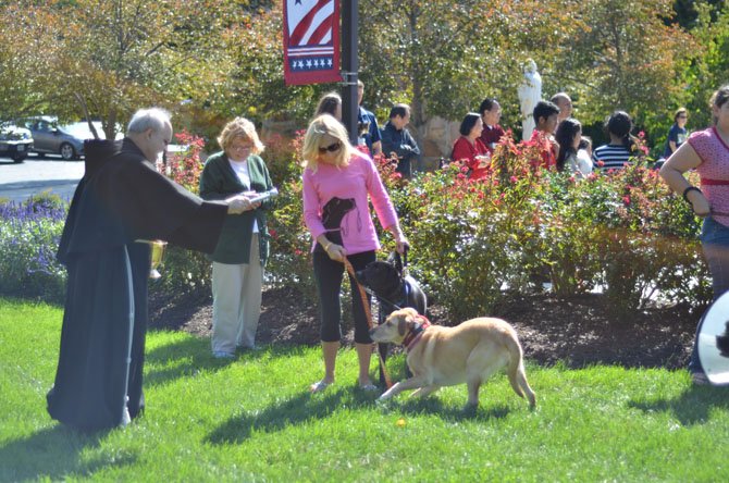 St. Joseph’s Church Vicars Alberto Bueno and Tom Bourque walked amongst the congregants to give blessing and sprinkle pets with holy water on Oct. 4 in Herndon, VA.