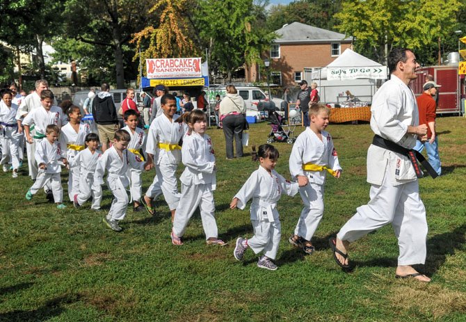 Master karate instructor and founder of Keichou Karate on N. Royal Street, Richard Romero leads a group of his students and staff to the Kid’s Stage for a karate demonstration.