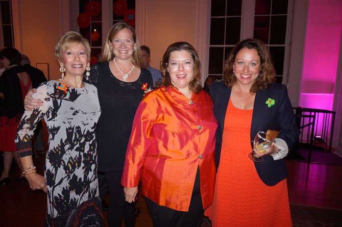 Northern Virginia Fine Arts Association board member Anne Kelly, NVFAA  board vice president Patricia Montague,  Athenaeum executive director Catherine Asleford and NVFAA board chair Amy Heiden pose for a photo Oct. 5 at the La Zona Rose benefit reception at the Athenaeum.