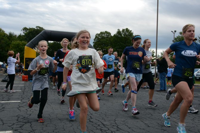 Nolan Dawson (center), a fifth grade student at George Mason Elementary School, takes off on a 5K run at Cameron Run Regional Park.
