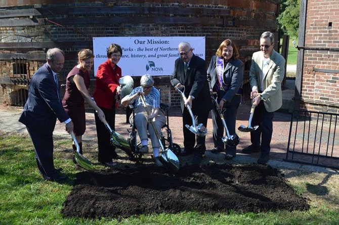 (From left) NOVA Parks Chairman Brian Knapp; NOVA Parks board member Laura Grape; Chairman of the Fairfax County Board of Supervisors Sharon Bulova; Jean R. Packard; U.S. Rep. Gerry Connolly; founder of the Turning Point Suffragist Memorial Jane Barker; and NOVA Parks Executive Director Paul Gilbert broke “virtual ground” on Sept. 27 at Occoquan Regional Park. Actual ground won’t be broken for several months.