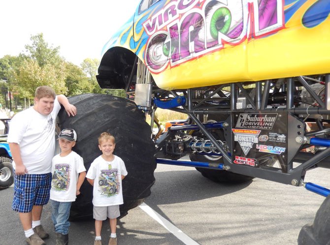The Gilbert brothers (from left): Travis, 14; Jacob, 6; and Chase, 5, stand next to their dad, Kris Gilbert’s, Monster Truck, the “Virginia Giant.” It’s a custom Ford with 66-inch tires, each weighing 700 pounds.
