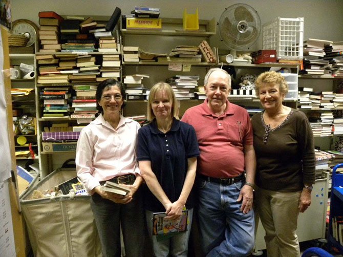 From left, Friends members Sonia Black, Margaret Merriman, of Springfield, Bob Atkins, Mary Storch, of Burke, sort and arrange book donations in the small space reserved for the Friends at Pohick Regional Library.
