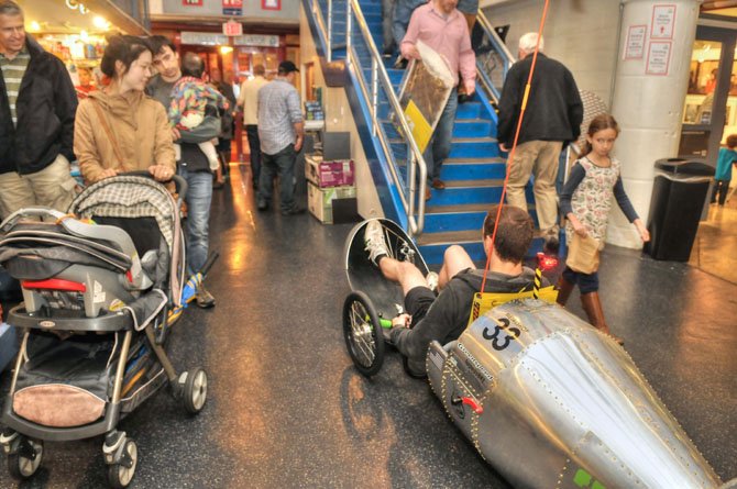 The “Torpedo Bike” makes it way through the throng of visitors at the Torpedo Factory on Saturday afternoon, Oct. 11.