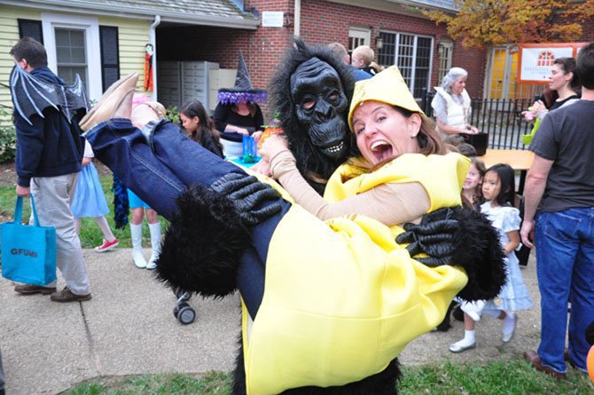 Ali Simanson, as a gorilla, steals away with a banana, played by Maribeth Burg, at last year’s Great Falls Halloween Spooktacular.
