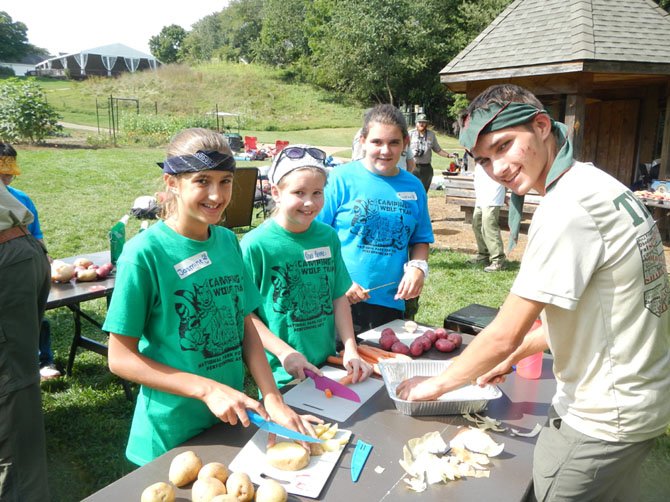 Jasmine Bhatia, Nora Reinke, Caroline Bennett and Nick Tagliatelle (scout) prepare a meal.
