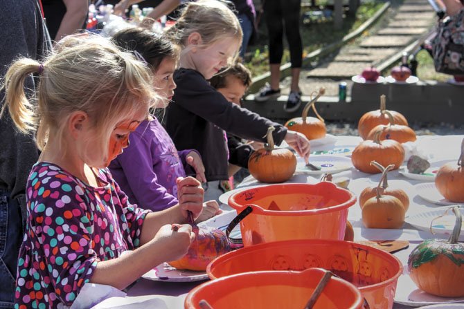  Kindergartener Juliet and friends paint pumpkins.