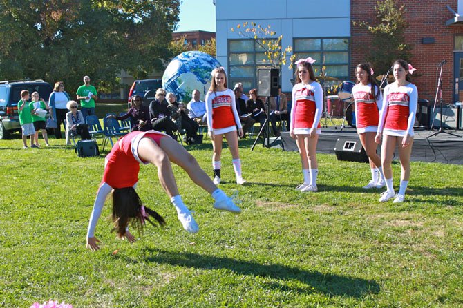 McLean High School cheerleader, junior Amber Tran Ha, does a series of back handsprings during Franklin Sherman Elementary’s centennial celebration.