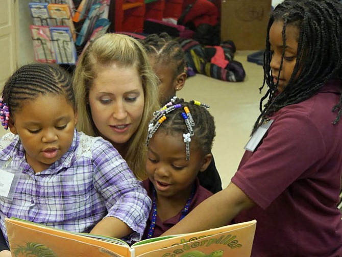 Diana Mertz, a monthly volunteer at The Reading Connection, reads "Clara Caterpillar” to her group at the Ruby Tucker Center in Alexandria.