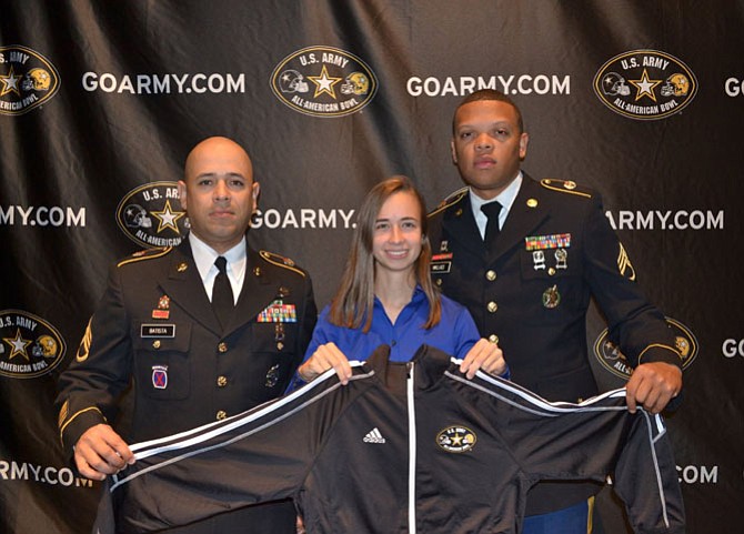 U.S. Army's SSG Batista and SSG Wallace present South Lakes High School trombone player Samantha Gifford with the 2015 U.S. Army All-American Marching Band jacket, representing her official selection as a 2015 U.S. Army All-American.
