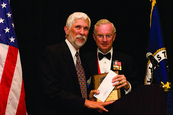 Alan Rems (on left) receives the 2008 Author of the Year award, plus a $5,000 prize, from Marine Maj. Gen. Thomas L. Wilkerson, former CEO of the U.S. Naval Institute.
