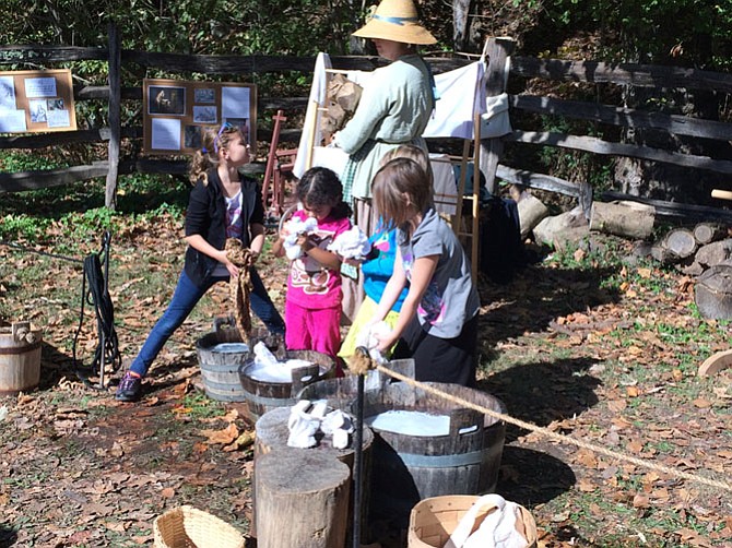 Children take part in soap making and laundry washing during Fall Harvest Family Days at Mount Vernon Estate.