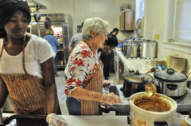  Mattie Ndearia works the counter in the kitchen.