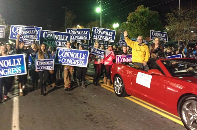 Rep. Gerry Connolly (D-11) and wife Cathy waving to crowd at the 68th Annual Vienna Halloween Parade Wednesday night. Connolly has participated every year since 1995.