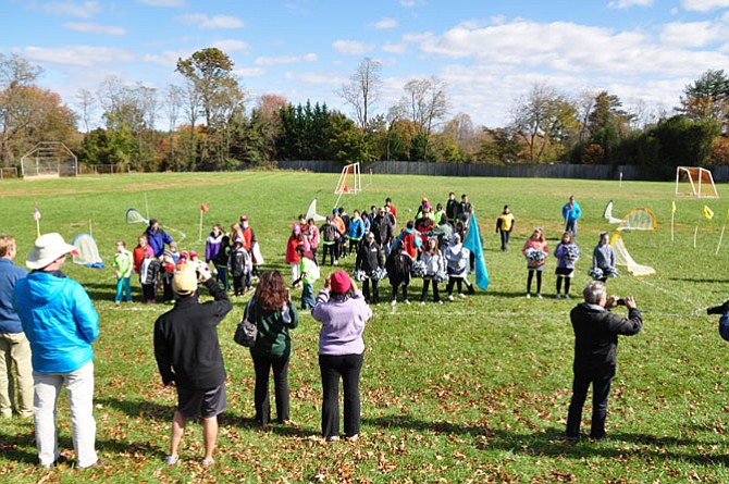 Soccer players line up on the field.