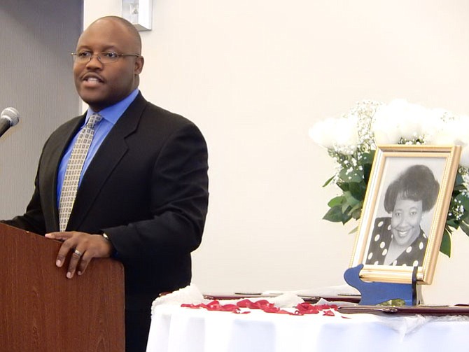 Mark Nelson speaks beside a photo of his late mother, Shirley Nelson.
