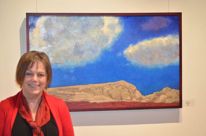 Artist Bobbi Pratte near one of her paintings on display until Nov. 30 at ArtSpace Herndon. ArtSpace Herndon is located at 750 Center Street in Herndon, VA.
