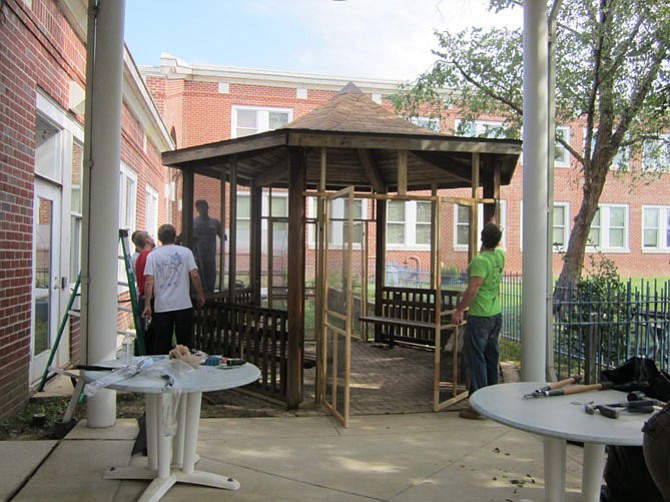 Volunteers construct a gazebo at the Adult Day Services Center.