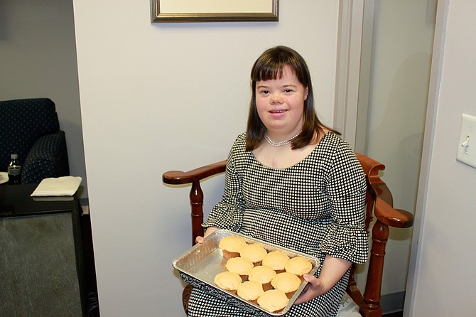 Charlotte Woodward poses with her famous cupcakes after her presentation on Friday.
