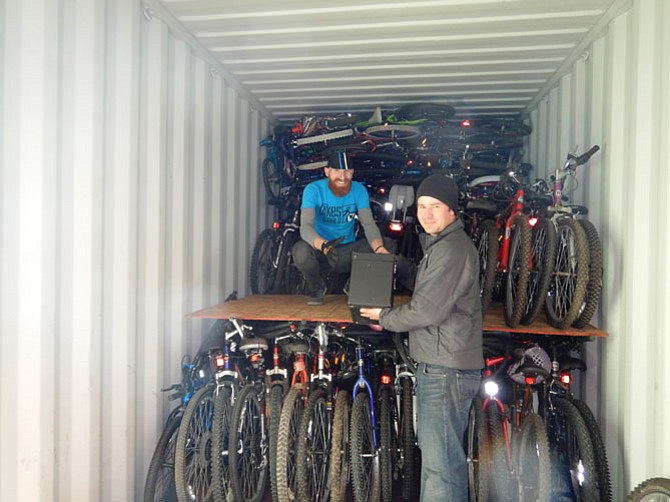 On America Recycles Day, Taylor Jones, Bikes for the World operations manager (rear), with Luis Jimenez, executive director, of Fundación Integral Campesina (FINCA Costa Rica), loads donated bicycles headed to Costa Rica for reuse. 