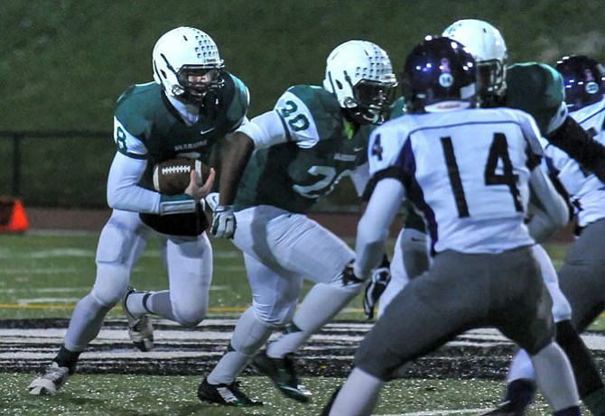 Senior quarterback Riley Wilson, left, and junior running back Kareem Hall (20) helped the Wakefield football team earn the first playoff victory in program history on Nov. 14 against Potomac Falls.