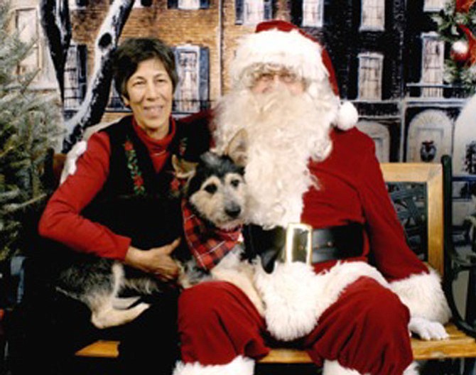 Adrienne and Joel Robert Cannon pose with their shelter dog Lucy. Joel Cannon served as a volunteer Santa at the photo sessions for many years.