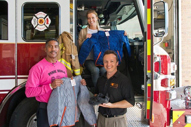 Captain II Willie Bailey (left), Erin McMullin with Operation Warm (center) and Niko Chakos with FOCUS North America (right) distributed 2,200 pairs of shoes and 2,000 coats Oct. 28 at Fire Station 11 with Firefighters and Friends to the Rescue.