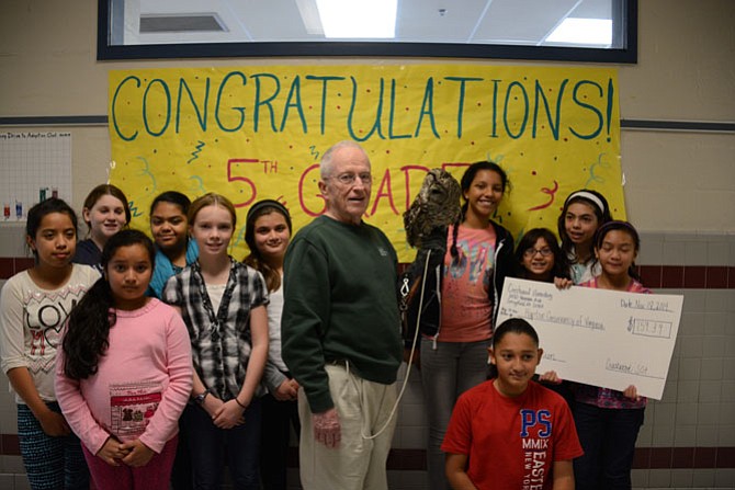 Students in Crestwood’s fifth grade class raised the most money in the school’s penny drive to adopt an owl from the Raptor Conservancy of Virginia. (From left) Jennifer Avila, Julia Bogstad, Franciso Martinez, Nataly Juarez, Bebe Dunlap, Marjan Nawaz, Kent Knowles and Sir Hoots-a-lot, Paola Gonzalez, Jolie Flores, Ashley Rodriguez, Tina Nguyen and (front) Angel Torres. 