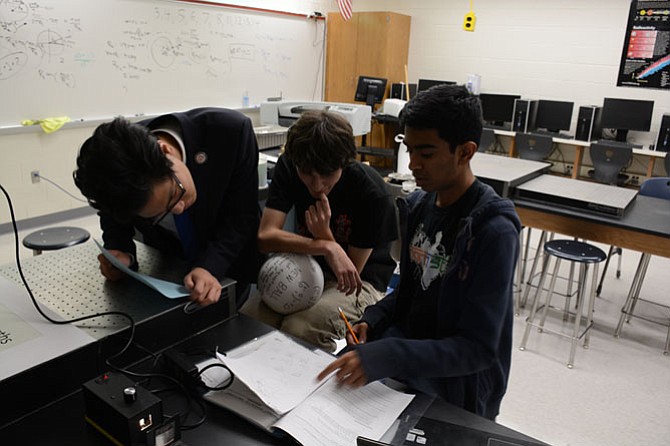 From left: Justin Yum of Woodbridge, Jacob Benheim of Fairfax, Nihar Gudiseva of Herndon study after school last fall in TJHSST new wing’s quantum physics and optics lab.